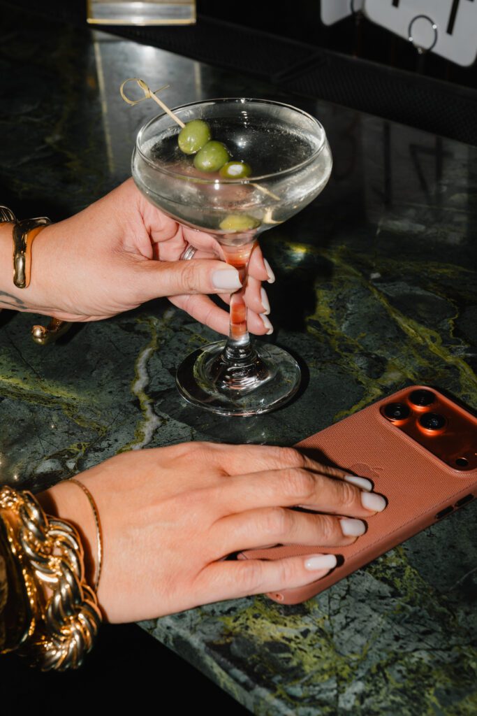 why is specificity important in Instagram content - Shannon McKinstrie with her phone and a dirty martini